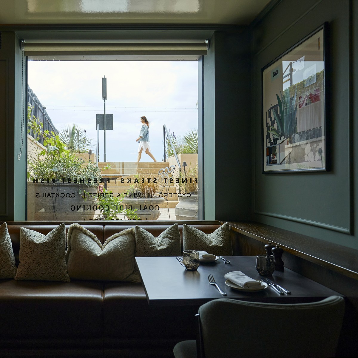 restaurant window with girl walking